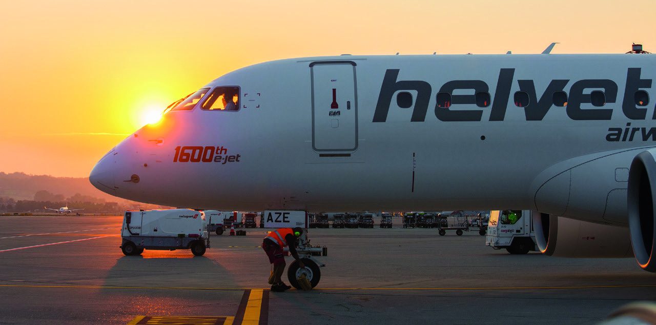 Helvetic Airways Embraer E-Jet on the apron at sunrise